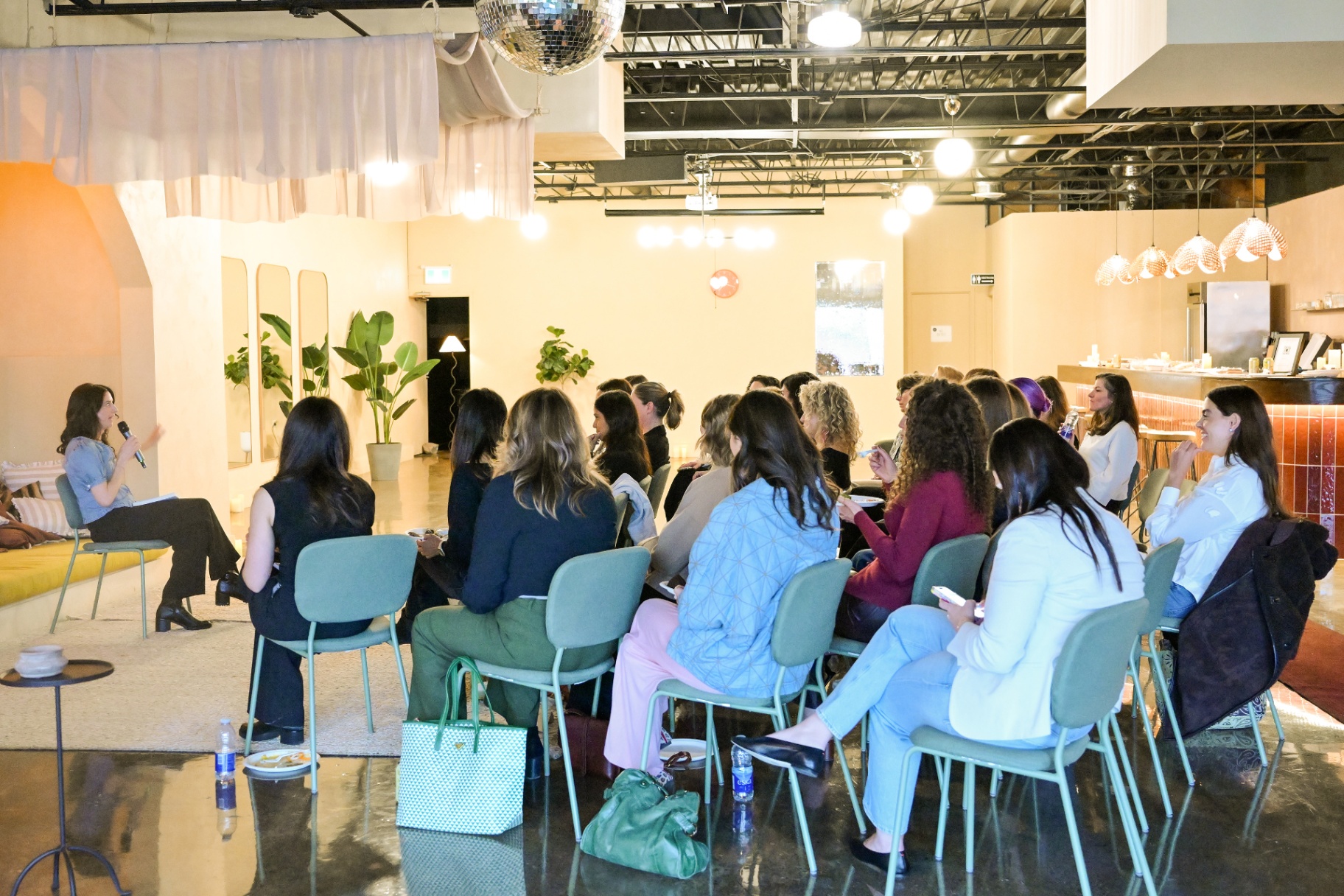 Fiona speaking to an engaged audience at an event